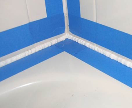 Preparing the bathtub rim for installing the curb Masking tape