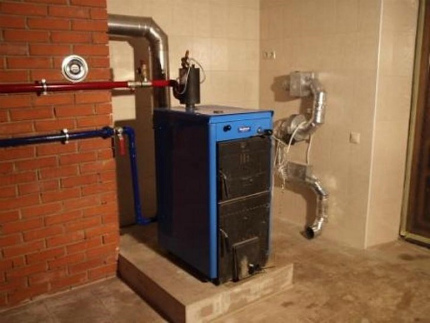 O esquema da construção de uma caldeira com caldeira a combustível sólido em uma casa particular Caldeira a combustível sólido