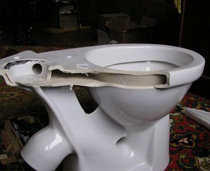 Damage - a reason to remove an old toilet Toilet bowl badly damaged