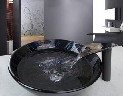 Waterfall design mixer mounted on a glass sink Glass sink with mixer tap
