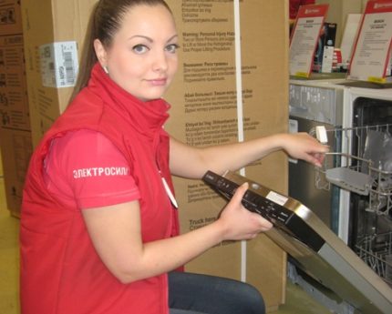 Un consultant montre un lave-vaisselle Vendeuse en magasin