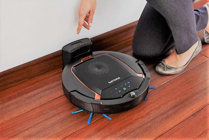 Robotic vacuum cleaner for home cleaning The vacuum cleaner is charging at the base
