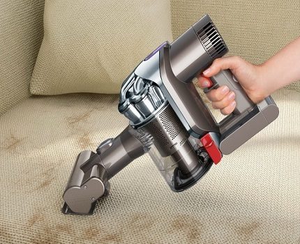 Cleaning the sofa with a vacuum cleaner Vacuum cleaner