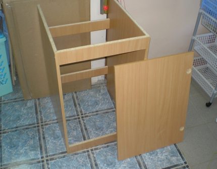 Holes in the door for hinges Assembled cabinet with door